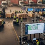 Logistics team ensuring timely delivery of exhibitor materials at a trade show venue with organized coordination