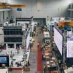 Event organisers coordinating large-scale exhibition setup with teams managing booths, logistics, and staging