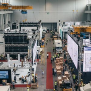 Event organisers coordinating large-scale exhibition setup with teams managing booths, logistics, and staging