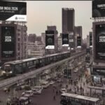 Hoardings, transit ads, and outdoor media displays promoting an exhibition across urban areas